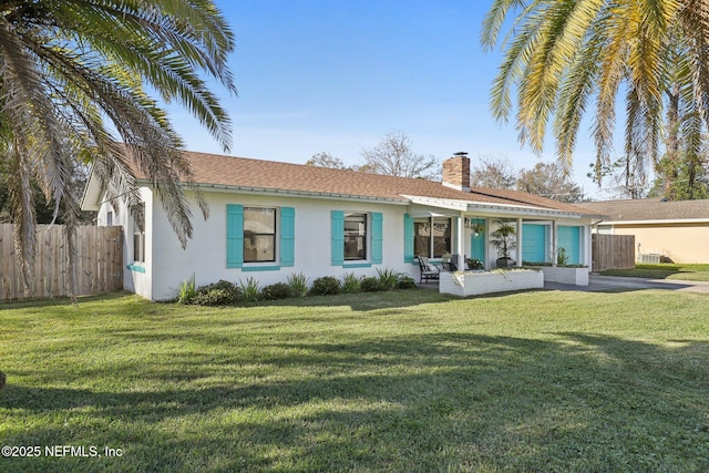 back of property featuring a lawn