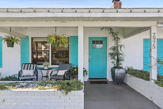 doorway to property featuring a porch