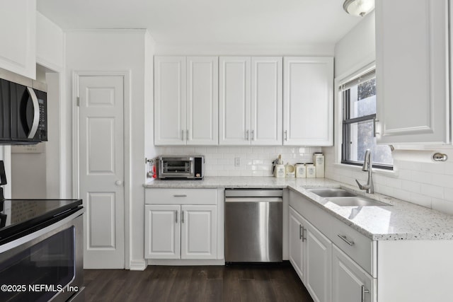 kitchen featuring white cabinets, stainless steel appliances, and sink