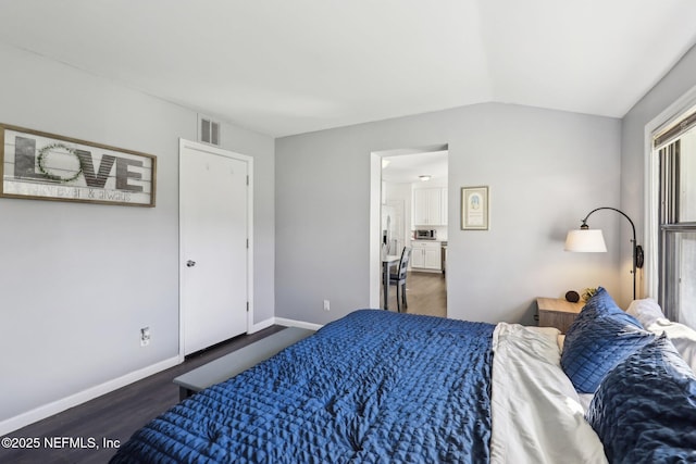 bedroom with dark hardwood / wood-style floors and vaulted ceiling