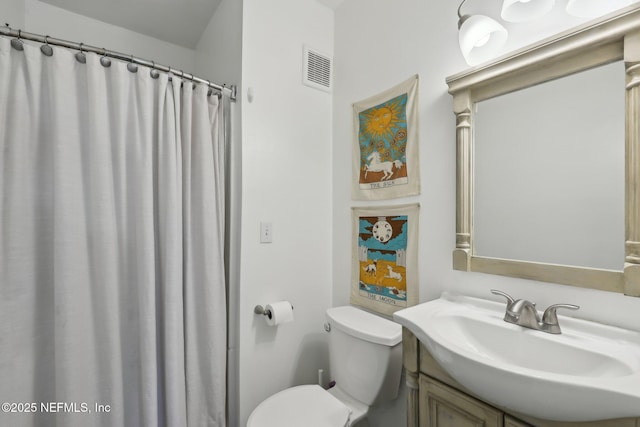 bathroom with a shower with shower curtain, vanity, and toilet