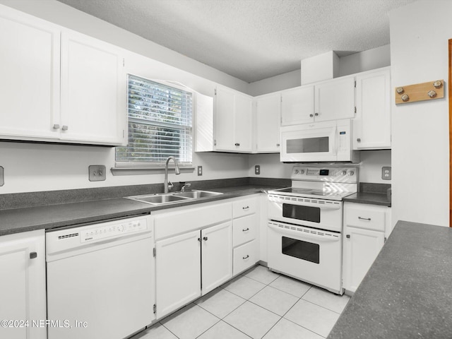 kitchen with white cabinetry, sink, a textured ceiling, white appliances, and light tile patterned floors