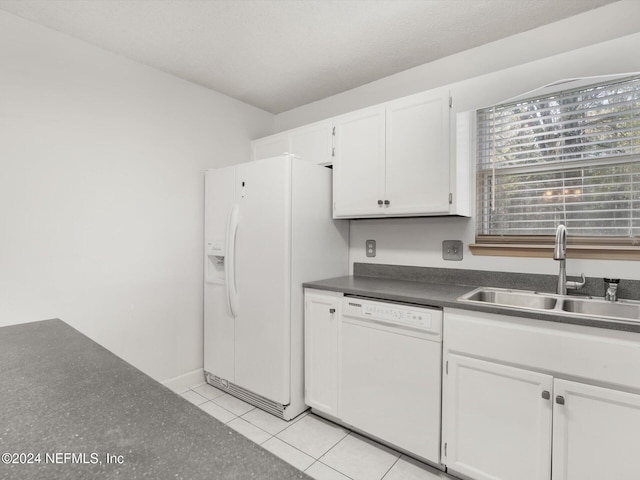 kitchen with light tile patterned floors, white appliances, white cabinetry, and sink