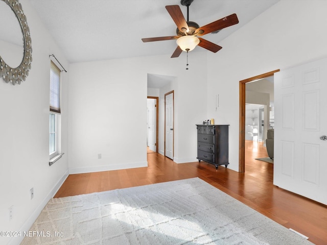 unfurnished bedroom featuring hardwood / wood-style floors, ceiling fan, and lofted ceiling