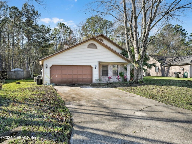 view of front of property with a garage and a front lawn