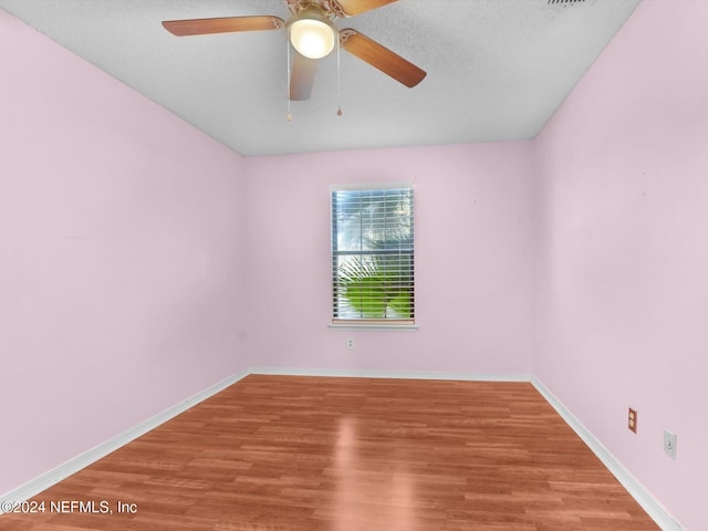 spare room featuring ceiling fan and hardwood / wood-style flooring