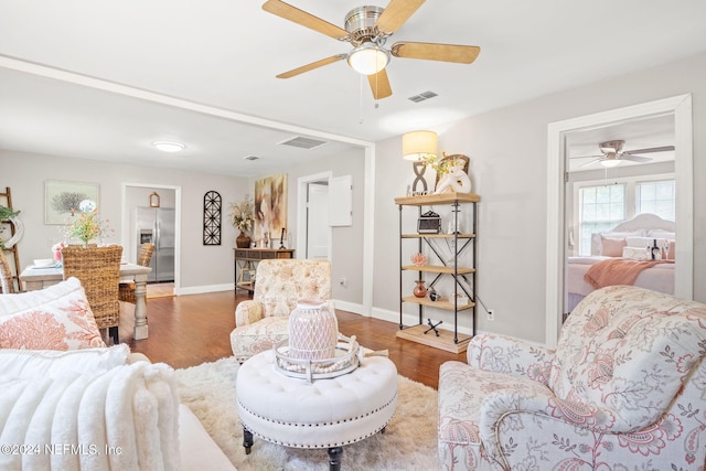 living room with hardwood / wood-style flooring and ceiling fan