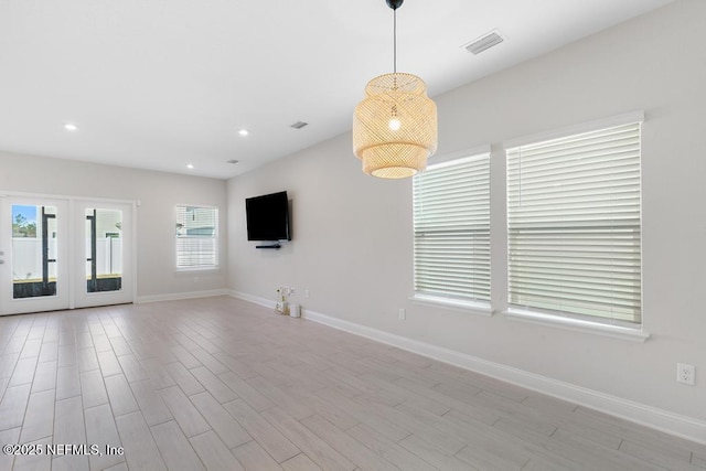 unfurnished living room with french doors