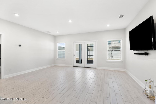 unfurnished living room featuring french doors