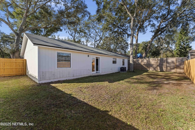 back of house with a lawn