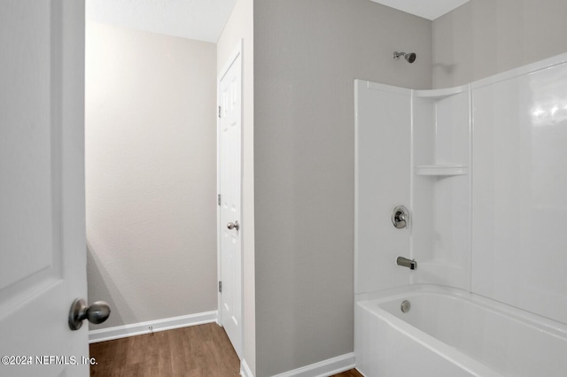 bathroom with wood-type flooring and bathtub / shower combination