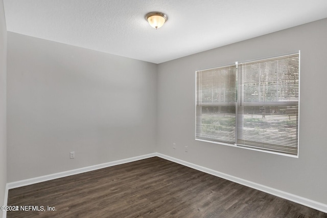 empty room featuring dark wood-type flooring