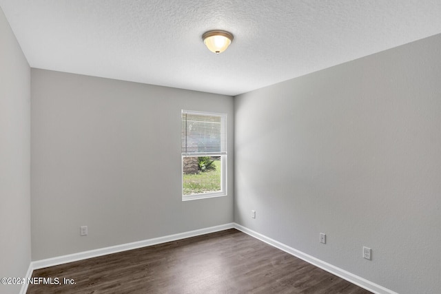 empty room with dark wood-type flooring