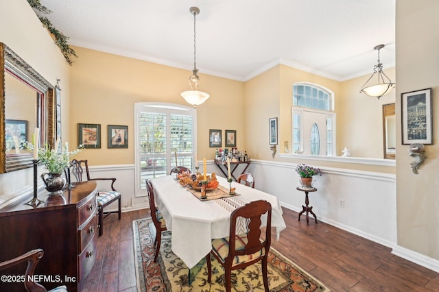 dining room with crown molding and dark hardwood / wood-style flooring