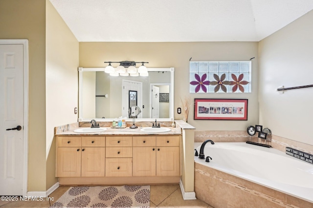 bathroom with vanity, tiled tub, and tile patterned floors