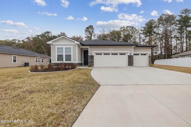 view of front of home featuring a garage and a front lawn