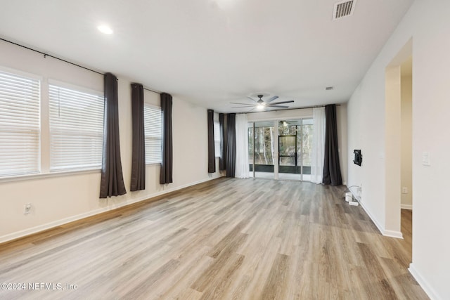 empty room with ceiling fan and light wood-type flooring