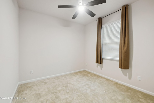 carpeted empty room featuring ceiling fan