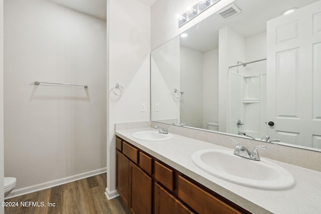 bathroom featuring vanity, toilet, and wood-type flooring