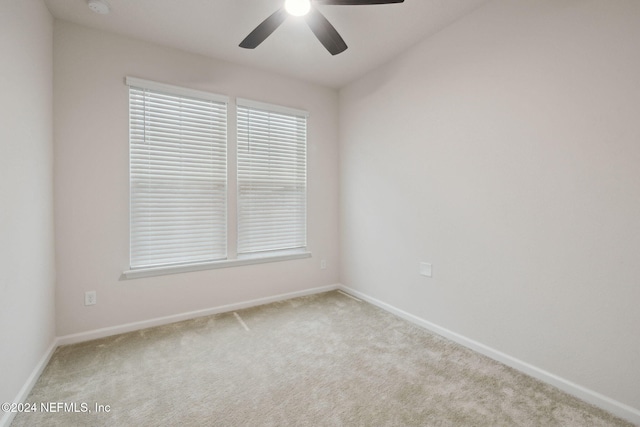 unfurnished room featuring light carpet and ceiling fan