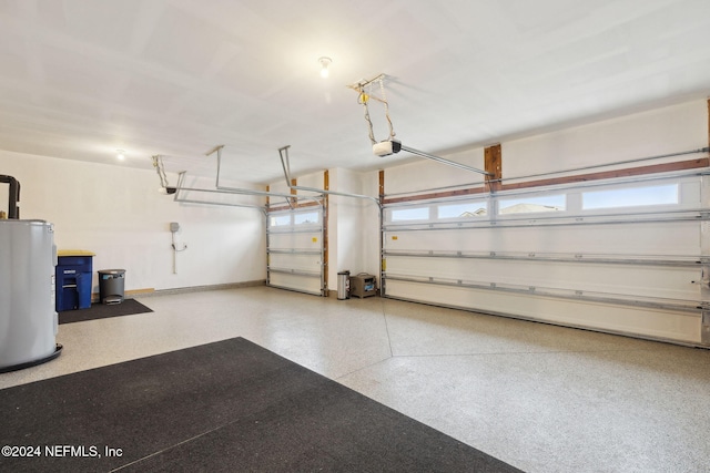 garage with electric water heater and a garage door opener