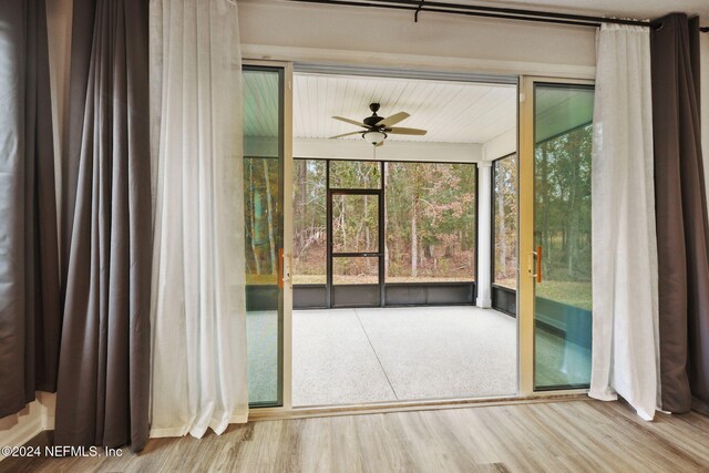 unfurnished sunroom featuring ceiling fan