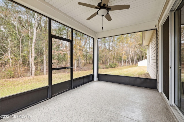 unfurnished sunroom with ceiling fan