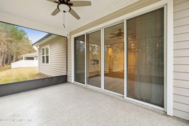 unfurnished sunroom with ceiling fan