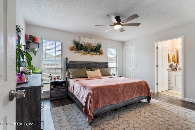 bedroom with dark hardwood / wood-style flooring, a textured ceiling, ensuite bathroom, and ceiling fan