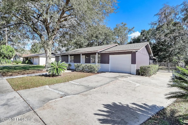 ranch-style house featuring a garage and a front yard