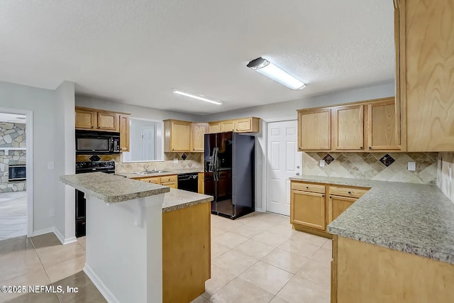 kitchen with light tile patterned floors, sink, backsplash, black appliances, and light brown cabinetry