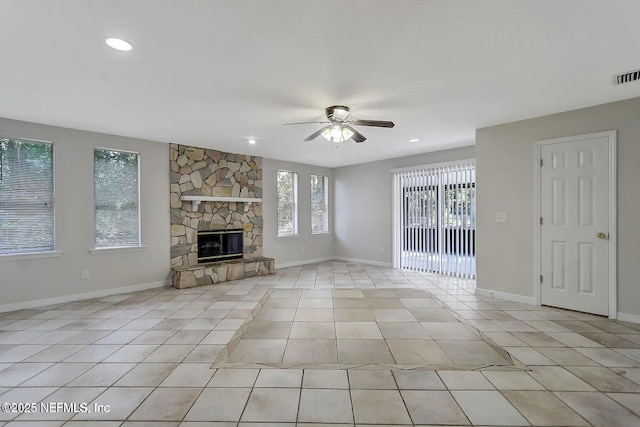 unfurnished living room featuring light tile patterned flooring, ceiling fan, and a fireplace