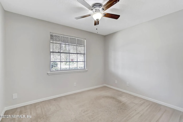 empty room with ceiling fan and light carpet