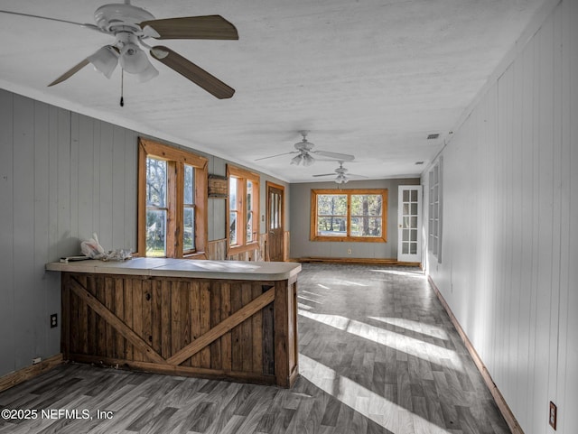 interior space featuring wood-type flooring, a wealth of natural light, and a hot tub