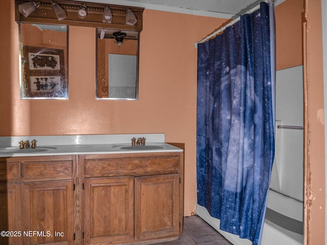 bathroom featuring tile patterned flooring, vanity, and walk in shower