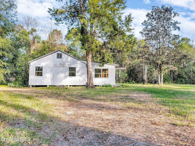 view of side of home featuring a yard