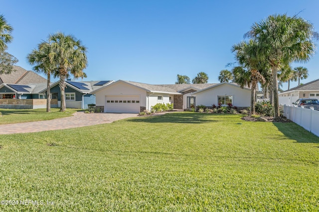 ranch-style house featuring solar panels, a garage, and a front lawn