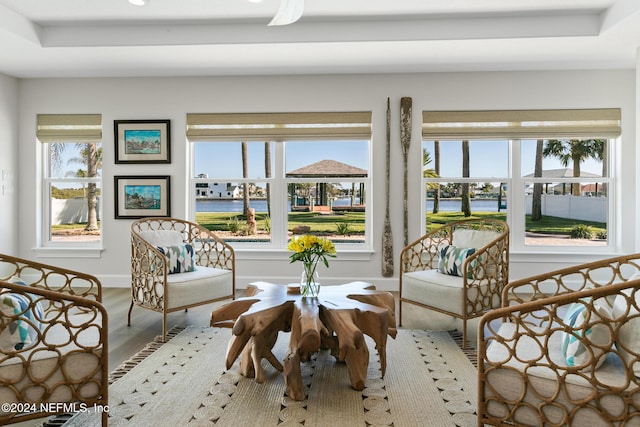 sitting room featuring hardwood / wood-style floors and a water view