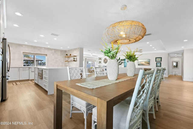 dining space featuring light wood-type flooring