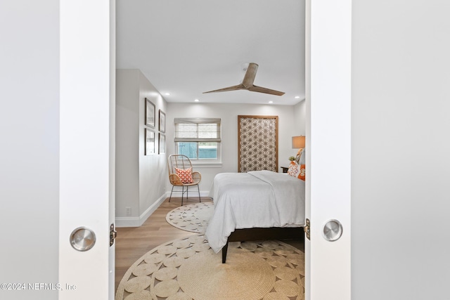 bedroom with ceiling fan and light hardwood / wood-style flooring