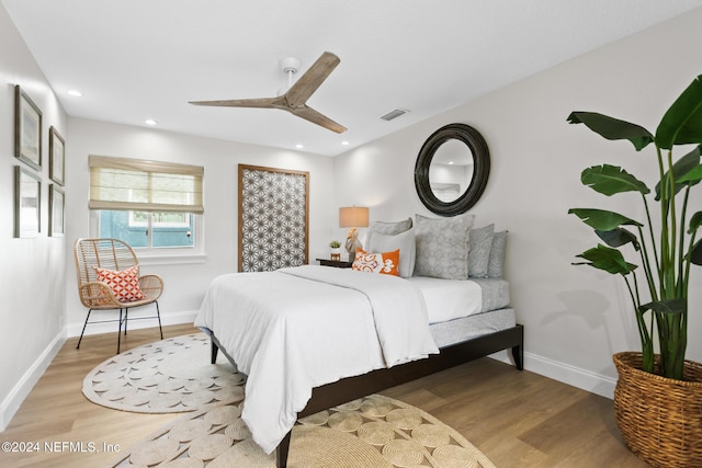 bedroom with hardwood / wood-style floors and ceiling fan