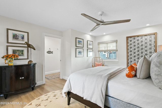 bedroom with ceiling fan and light wood-type flooring