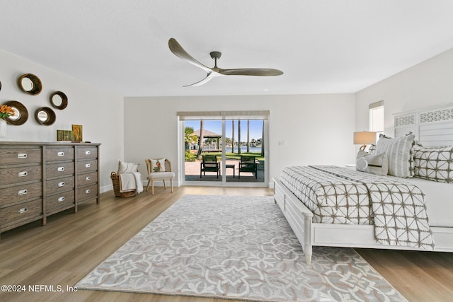 bedroom featuring access to exterior, hardwood / wood-style floors, and ceiling fan