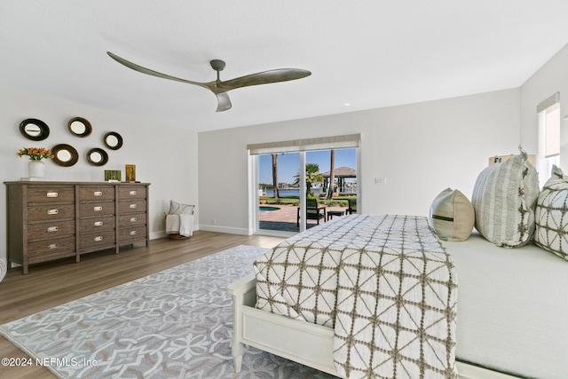 bedroom featuring hardwood / wood-style flooring, ceiling fan, and access to exterior