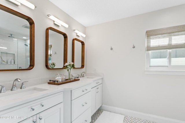 bathroom with tile patterned flooring, vanity, and walk in shower