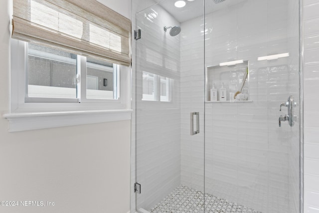 bathroom featuring a shower with shower door