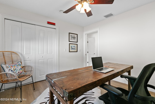 office with ceiling fan and light hardwood / wood-style flooring