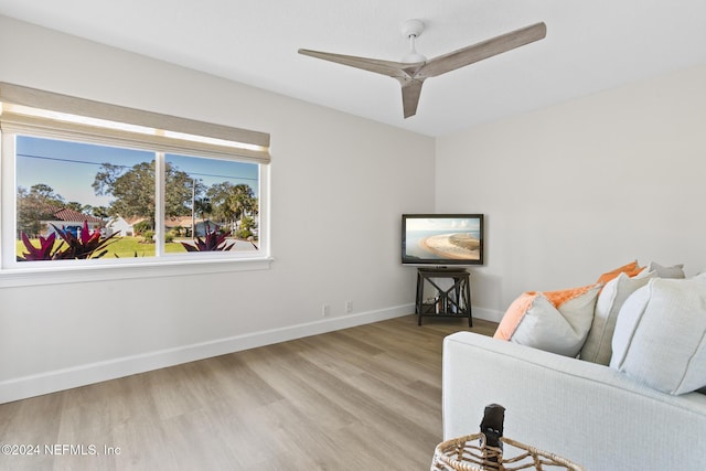 living room featuring light wood-type flooring and ceiling fan