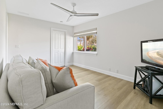 living room with ceiling fan and light wood-type flooring