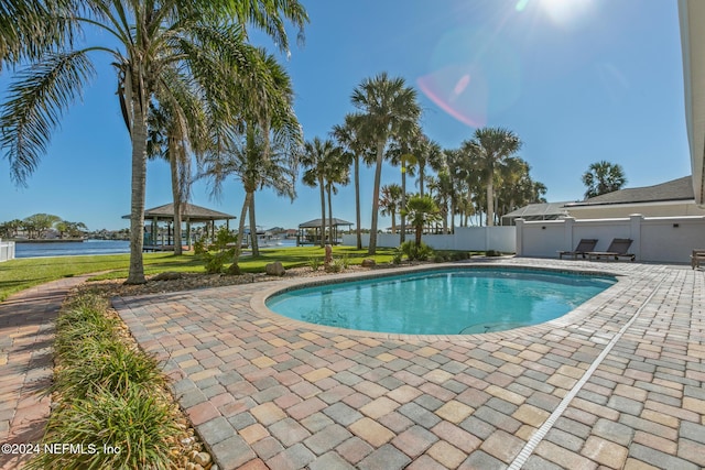 view of pool featuring a gazebo, a patio area, and a water view